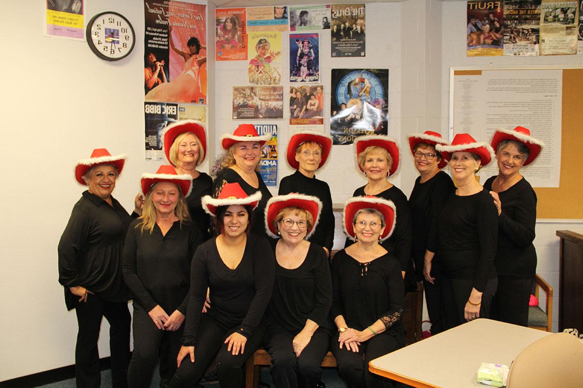 Group of dancers in red cowboy hats